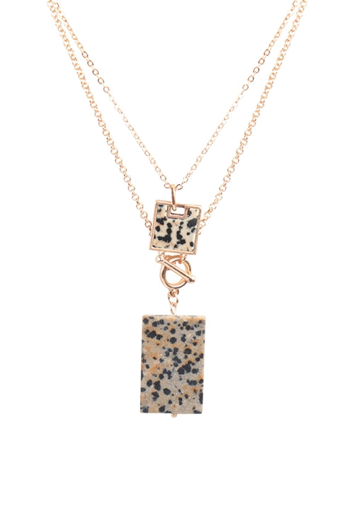 Layered gold necklace with spotted pendant