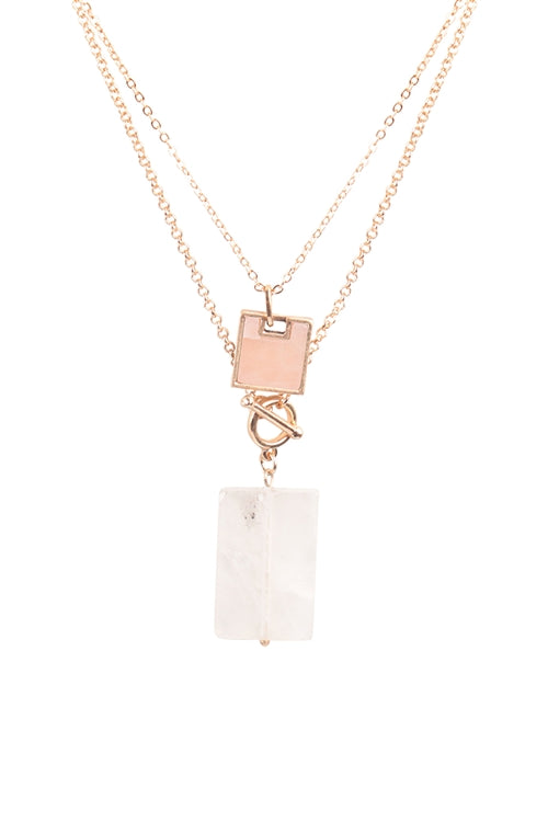 Layered gold necklace with blush pendant